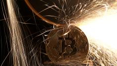 FILE PHOTO: Sparks glow from broken Bitcoin (virtual currency) coins in this illustration picture, December 8, 2017. REUTERS/Dado Ruvic/Illustration/File Photo