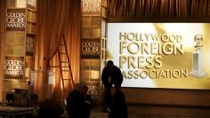Crew members work on stage in front of set for 65th annual Golden Globe Awards news conference in Beverly Hills