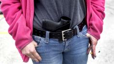 File photo of Thompson carrying her 9mm Smith & Wesson pistol in her waist band during a rally in support of the Michigan Open Carry gun law in Romulus, Michigan