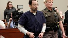 Larry Nassar, a former team USA Gymnastics doctor, who pleaded guilty in November 2017 to sexual assault charges, is led from the courtroom after listening to victim testimony during his sentencing hearing in Lansing, Michigan, U.S., January 23, 2018. RE