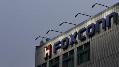 FILE PHOTO: The logo of Foxconn, the trading name of Hon Hai Precision Industry, is seen on top of the company's headquarters in New Taipei City, Taiwan