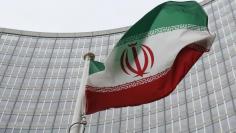 An Iranian flag flutters in front of the International Atomic Energy Agency (IAEA) headquarters in Vienna, Austria, January 15, 2016.   REUTERS/Leonhard Foeger