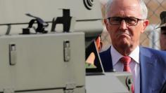 Australian Prime Minister Malcolm Turnbull looks around a Bushmaster military vehicle at Narashino exercise field in Funabashi