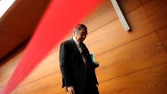Bank of Japan (BOJ) Governor Haruhiko Kuroda is seen behind a photo line as he leaves from a venue after his news conference at the BOJ headquarters in Tokyo, Japan January 23, 2018. REUTERS/Kim Kyung-Hoon