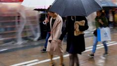 FILE PHOTO: Shoppers walk through the rain in an Osaka shopping district in western Japan October 22, 2017.   REUTERS/Thomas White/File Photo                               GLOBAL BUSINESS WEEK AHEAD.   SEARCH GLOBAL BUSINESS 22 JAN FOR ALL IMAGES