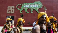 FILE PHOTO: Performers walk at the exhibition centre of the 'Make In India' week in Mumbai