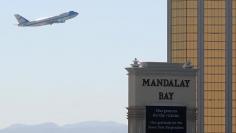 FILE PHOTO: Air Force One departs Las Vegas past the a sign in front of Mandalay Bay hotel where shooter Stephen Paddock conducted his mass shooting along the Las Vegas Strip in Las Vegas, Nevada, U.S., October 4, 2017.  REUTERS/Mike Blake