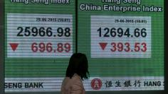 A panel displaying the closing Hang Seng Index and Hang Seng China Enterprise Index are shown outside a bank in Hong Kong