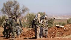 Rebel fighters gather during their advance towards the Islamic State-held city of al-Bab