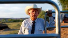FILE PHOTO: Rancher Cliven Bundy stands near a cattle gate on his 160 acre ranch in Bunkerville, Nevada, U.S., May 3, 2014.  REUTERS/Mike Blake/File Photo