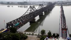 Trucks cross Friendship Bridge from China's Dandong, Liaoning province, to North Korea's Sinuiju