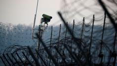 A surveillance camera stands on a barbed-wire fence near the militarized zone separating the two Koreas, in Paju, South Korea, December 21, 2017.  REUTERS/Kim Hong-Ji