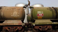 A worker walks atop a tanker wagon to check the freight level at an oil terminal on the outskirts of Kolkata, India in this November 27, 2013 file photo.    REUTERS/Rupak De Chowdhuri/Files 