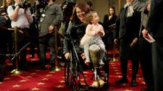 FILE PHOTO: Senator Duckworth (D-IL) carries her daughter Abigail during a mock swearing-in in Washington