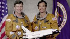FILE PHOTO: NASA handout photo of John Young and Robert Crippen with a model of the Space Shuttle Columbia