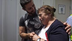 An Israeli parent is greeted by his grandmother in Tel Aviv