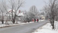 People walk on the main road of Dragomiresti