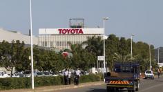 FILE PHOTO - Vehicles drive past Toyota plant in Durban