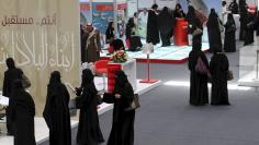 File photo of jobseekers standing in line to talk with recruiters during a job fair in Riyadh