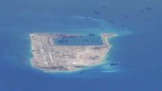 Chinese dredging vessels are purportedly seen in the waters around Fiery Cross Reef in the disputed Spratly Islands in this still image from video taken by a P-8A Poseidon surveillance aircraft provided by the United States Navy May 21, 2015. REUTERS/U.S.