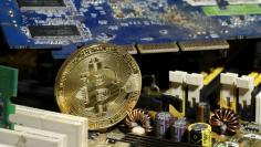 FILE PHOTO: A copy of bitcoin standing on PC motherboard is seen in this illustration picture, October 26, 2017. REUTERS/Dado Ruvic/File Photo
