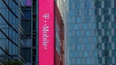 FILE PHOTO:    A T-Mobile logo is advertised on a building sign in Los Angeles, California, U.S., May 11, 2017. REUTERS/Mike Blake/File Photo