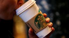 FILE PHOTO: A customer sips her coffee in Starbucks' Mayfair Vigo Street branch in central London, Britain, September 12, 2012. REUTERS/Andrew Winning/File Photo