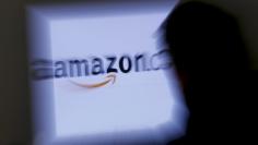 A zoomed illustration image of a man looking at a computer monitor showing the logo of Amazon is seen in Vienna November 26, 2012. To match Special Report TAX-AMAZON  REUTERS/Leonhard Foeger  