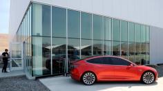 A prototype of the Tesla Model 3 is on display in front of the factory during a media tour of the Tesla Gigafactory which will produce batteries for the electric carmaker in Sparks, Nevada, U.S. July 26, 2016.  REUTERS/James Glover II 