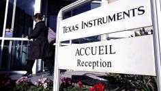 FILE PHOTO: An employee enters the research building of Texas Instruments France in Villeneuve-Loubet