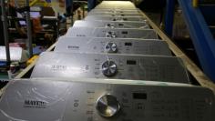 Washing machine parts move along a conveyor belt waiting to be assembled  at a Whirlpool plant in Clyde