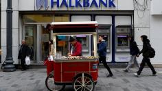 A street vendor sells roasted chestnuts in front of a branch of Halkbank in central Istanbul, Turkey, January 10, 2018. REUTERS/Murad Sezer