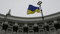 FILE PHOTO: Ukrainian national flag flies in front of Government building in central Kiev