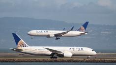 FILE PHOTO - A United Airlines 787 taxis as a United Airlines 767 lands at San Francisco International Airport, San Francisco