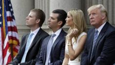 (L-R) Eric Trump, Donald Trump Jr., and Ivanka Trump and Donald Trump attend the ground breaking of the Trump International Hotel at the Old Post Office Building in Washington July 23, 2014.  REUTERS/Gary Cameron  