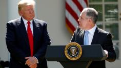 FILE PHOTO: U.S. President Donald Trump listens to EPA Administrator Scott Pruitt after announcing his decision that the United States will withdraw from the Paris Climate Agreement, in the Rose Garden of the White House in Washington, U.S., June 1, 2017