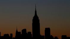 A view of the Empire State building and midtown Manhattan skyline of New York City at sunrise as seen from Hoboken, New Jersey, U.S., August 9, 2017. REUTERS/Mike Segar