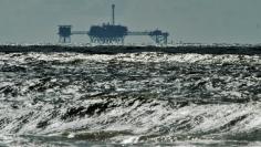 FILE PHOTO: An oil and gas drilling platform stands offshore near Dauphin Island, Alabama