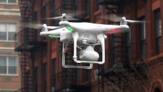 A camera drone operated by a civilian flies near the scene where two buildings were destroyed in an explosion in New York, in this file photo taken March 12, 2014. REUTERS/Mike Segar/Files
