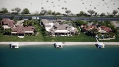 FILE PHOTO: Homes with boathouses built around an artificial lake are seen in Indio, California April 13, 2015.  REUTERS/Lucy Nicholson/File Photo  
