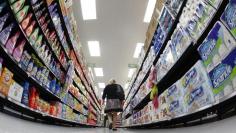 FILE PHOTO: A shopper walks down an aisle in a newly opened Walmart Neighborhood Market in Chicago in this September 21, 2011 file photo. REUTERS/Jim Young/Files  
