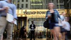 A doorman stands as people walk past the Trump Tower in New York, U.S., May 23, 2016.  REUTERS/Carlo Allegri/File Photo