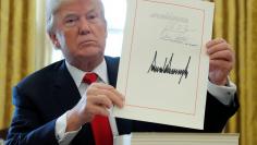 FILE PHOTO:  U.S. President Trump displays signature after signing tax bill into law at the White House in Washington
