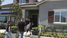 Prospective home owners tour a community being developed by builder D.R. Horton in Jurupa Valley, California