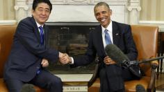 U.S. President Barack Obama (R) greets Japanese Prime Minister Shinzo Abe during a White House Oval Office meeting in Washington, April 28, 2015. REUTERS/Kevin Lamarque 