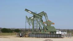 FILE PHOTO - A pump jack used to help lift crude oil from a well in South Texas’ Eagle Ford Shale formation stands idle in Dewitt County Texas