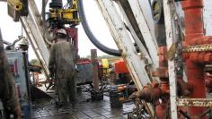 FILE PHOTO: Workers drill a horizontal well in the Wolfcamp Shale in west Texas Permian Basin near the town of Mertzon Texas