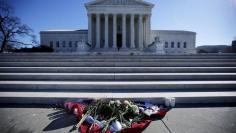 Flowers are seen in front of the Supreme Court building in Washington D.C. after the death of U.S. Supreme Court Justice Antonin Scalia, February 14, 2016. REUTERS/Carlos Barria