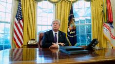 Trump signs directives to impose tariffs on washing machines and solar panels in the Oval Office at the White House in Washington