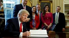 FILE PHOTO: Trump signs an executive order at the White House in Washington
